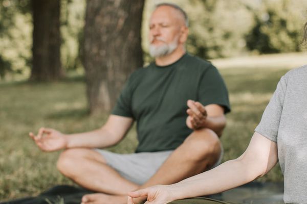 Close-up of yoga mat and hands in a zen position.