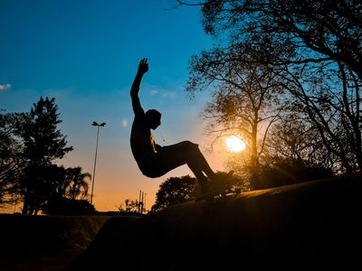 Silhouette of a person doing a balance pose.